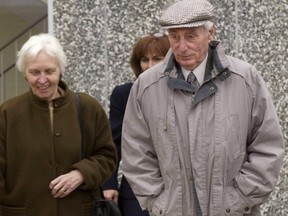 Helmut Oberlander (right), his wife, Margret (left), and daughter, Irene Rooney (centre behind) leave a courthouse in Kitchener on Nov. 4, 2003.