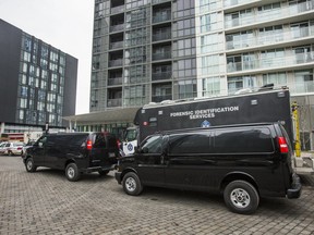 Police at the condo building where three men were murdered and two others were injured during a shooting last Friday night.