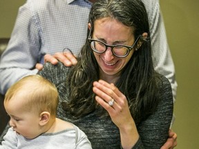 Jennifer Kagan cries while holding her 8-month-old son Joseph during an media interview in their condo building in Thornhill, Ont. on Monday, February 10, 2020. The bodies of her four-year-old daughter, Keira, and the child’s biological father were found at Rattlesnake Point Conservation Area. (Ernest Doroszuk/Toronto Sun)