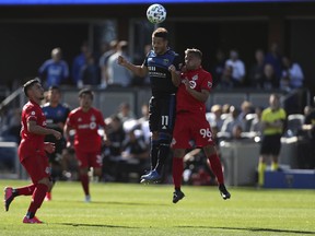 San Jose Earthquakes' Vako (11) battles for the ball with Toronto FC's Auro Jr (96) during the first half of an MLS soccer game in San Jose, Calif., Saturday, Feb. 29, 2020. (AP Photo/Jed Jacobsohn)