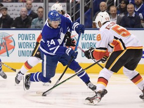 Toronto Maple Leafs forward Kasperi Kapanen (24) shoots the puck past Calgary Flames defenseman Oliver Kylington (58) in the second period at Scotiabank Arena. Dan Hamilton-USA TODAY