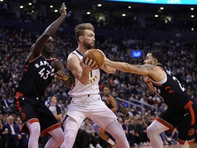 Pacers forward Domantas Sabonis is double-teamed by Pascal Siakam (left) and Fred VanVleet of the Raptors last night at Scotiabank Arena. John E. Sokolowski/USA TODAY