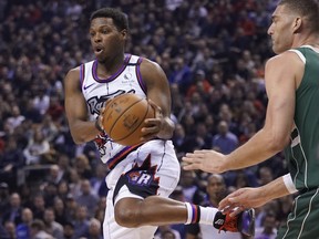 Raptors guard Kyle Lowry keeps the ball away from Bucks centre Brook Lopez during the first half at Scotiabank Arena last night. John E. Sokolowski/USA TODAY Sports ORG