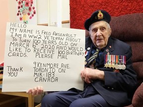 Pte. Fred Arsenault holds up a sign asking for 100 birthday cards for his upcoming birthday on March 6. The photos has gone viral with Toronto Mayor John Tory and Premier Doug Ford tweeting out the request on social media.