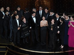 "Parasite" cast and crew accept the award for Best Picture for "Parasite" during the 92nd Oscars at the Dolby Theatre in Hollywood, California on Feb. 9, 2020. (MARK RALSTON/AFP via Getty Images)