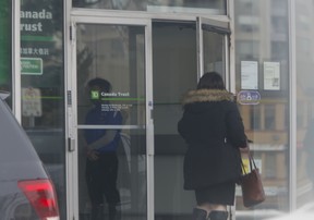 After a rash of bank robberies in the GTA, security has been stepped up at many branches. A security guard is seen here posted at the door to a TD branch near Leslie St. and Hwy. 7 in Richmond Hill on Wednesday, Feb. 12, 2020. (Chris Doucette/Toronto Sun/Postmedia Network)
