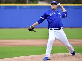 Toronto Blue Jays starting pitcher Hyun-Jin Ryu throws a pitch from the mound for live batting practice during spring training at Spectrum Field.