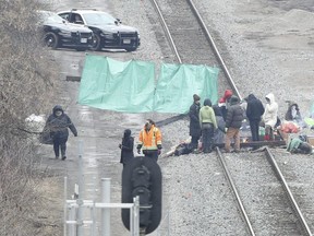 Protestors block the CN rail line between Hamilton and Aldershot GO station in Burlington on Tuesday.