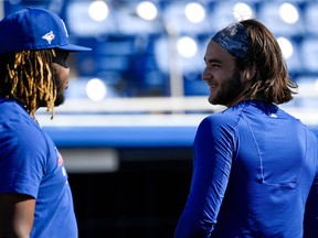 Blue Jays third baseman Vladimir Guerrero Jr. (left) and shortstop Bo Bichette share a lighter moment during spring training at Spectrum Field in Dunedin on Saturday. The teammates weighed in on the Astros sign-stealing scandal, a topic that isn’t likely to go away any time soon. (USA TODAY SPORTS)