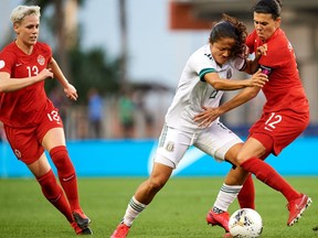 Canada forward Christine Sinclair, right, battles with Kiana Palacios of Mexico as Sophie Schmidt looks on at the CONCACAF Olympic qualifying tournament in Edinburg, Texas on Tuesday, Feb. 4, 2020. Canada won 2-0