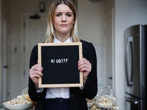 A former drug mule and convicted criminal, entrepreneur Emily O'Brien holds her prison number.