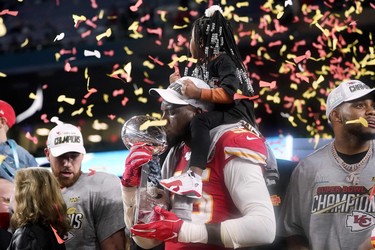 Kansas City Chiefs defensive end Frank Clark kisses the trophy as he celebrates after winning Super Bowl LIV against the San Francisco 49ers at Hard Rock Stadium in Miami on February 2, 2020. (TIMOTHY A. CLARY/AFP via Getty Images)