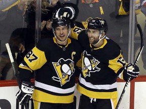 Pittsburgh Penguins left wing Jason Zucker (R) reacts with centre Sidney Crosby after scoring a goal against the Montreal Canadiens during the second period at PPG PAINTS Arena in Pittsburgh, Pa., on Feb. 14, 2020.