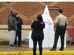 A black man wearing a KKK robe was confronted by cops in Virginia. (Twitter)