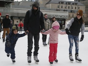 A family from Peterborough, Ontario skate at Nathan Phillips Square on Tuesday, Feb. 11, 2020. Rebecca and Bryce Burows with their children Salba (6) and Danik (5). (Veronica Henri/Toronto Sun/Postmedia Network)