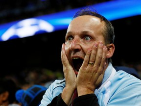 A Manchester City fan   watches Champions League action. (Jason Cairnduff/Reuters File Photo)
