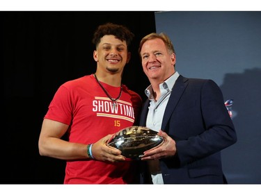 Commissioner of the National Football League Roger Goodell presents  Kansas City Chiefs quarterback Patrick Mahomes Super Bowl MVP trophy at Hilton Miami.