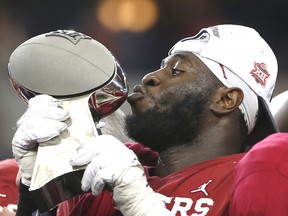 Neville Gallimore of the Oklahoma Sooners kisses the trophy after Oklahoma defeated the Baylor Bears 30-23 in the Big 12 Football Championship at AT&T Stadium on December 7, 2019 in Arlington. (Ron Jenkins/Getty Images)