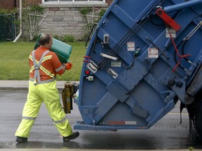 A Toronto city garbage collector is pictured in this undated file photo. (Jack Boland/Toronto Sun archives)