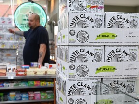 Cartons of White Claw, a flavored alcoholic fizz in a can are on display at the Round The Clock Deli September 11, 2019 in New York City.