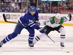 Toronto Maple Leafs forward Jason Spezza moves the puck past Dallas Stars defenseman Esa Lindell in the second period at Scotiabank Arena.