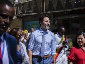 Prime Minister Justin Trudeau, centre, is accompanied by Samrawit Moges, centre-left, Founder and Co-Director of Travel Ethiopia, and Mary Ng, right, Canada's Minister of Small Business, Export Promotion and International Trade, as they arrive at the Yod Abyssinia traditional restaurant for a meeting with Ethiopian women entrepreneurs, in Addis Ababa, Ethiopia on Feb. 9, 2020.