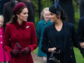 Kate Middleton and Meghan Markle walk together in Sandringham, England.