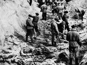 A picture taken on April 1, 1943, shows men digging out bodies of Polish officers from a mass grave in Katyn.(AFP/Getty Images)