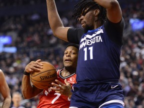 Raptors’ Kyle Lowry (7) hangs onto the ball as Minnesota Timberwolves’ Naz Reid defends on Monday. It was the Raps’ 15th stragith victory. (FRANK GUNN/THE CANADIAN PRESS)