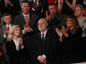 Radio personality Rush Limbaugh is honoured by U.S. President Donald Trump with a Presidential Medal of Freedom as he stands with first lady Melania Trump during the State of the Union address to a joint session of the U.S. Congress in the House Chamber of the U.S. Capitol in Washington, D.C., Feb. 4, 2020.