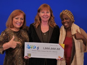 Maria Salustiano, Christine Maleta and Julie Joseph pose with their prize cheque as part of a group of 14 co-workers of a Hamilton homeless shelter who won $1 million in the Lotto Max draw on Jan. 7. SUPPLIED/OLG