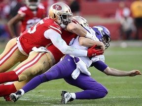 Kirk Cousins of the Minnesota Vikings is sacked by Nick Bosa and Dee Ford of the San Francisco 49ers during the NFC Divisional Round playoff game at Levi's Stadium on January 11, 2020 in Santa Clara, California. (Sean M. Haffey/Getty Images)