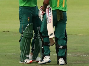 South Africa’s Quinton de Kock (left) celebrates his century with Temba Bavuma on Tuesday against England at the Newlands Cricket Ground in Cape Town. (REUTERS PHOTO)