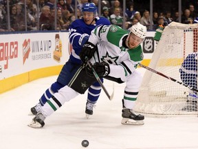 Stars forward Radek Faksa (front) battles for the puck against Maple Leafs defenceman Tyson Barrie during first period NHL action at Scotiabank Arena in Toronto on Thursday, Feb. 13, 2020.