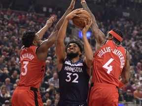 Minnesota Timberwolves centre Karl-Anthony Towns tries for a basket between Raptors forwards OG Anunoby 
and Rondae Hollis-Jefferson at Scotiabank Arena last night. USA TODAY