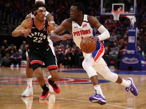 Pistons' Reggie Jackson (right) drives around Raptors' Patrick McCaw (left) during first half NBA acton at Little Caesars Arena in Detroit, on Friday, Jan. 31, 2020.
