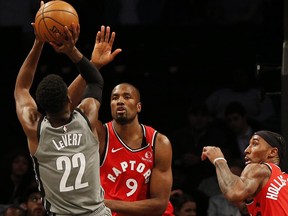 Nets guard Caris LeVert (left) shoots against Raptors centre Serge Ibaka (centre) during first half NBA action at Barclays Center in Brooklyn, N.Y., on Wednesday, Feb. 12, 2020.