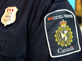 A Canadian Border Services Agency (CBSA) officer's shoulder flash is shown at the Calgary Courts Centre on April 22, 2017.
