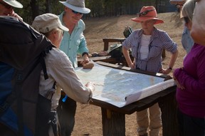 On the Arkaba Walk in a remote corner of South Australia, the day’s route is planned out the old-fashioned way, with a map. (Peter Neville-Hadley/Horizon Writers’ Group)