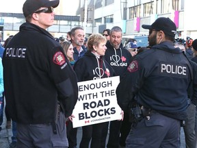Calgary Police watch protesters for and against Teck's Frontier mine met outside the company's office in downtown Calgary on Jan. 22, 2020. (Jim Wells/Postmedia Network)