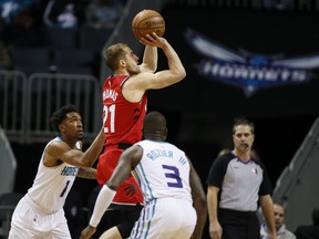 Raps’ Matt Thomas unloads a jumper against the Hornets in Charlotte, N.C., back in January. Though he was sidelined for more than a month with an injury, Raptors’ rookie guard, Thomas has been exceptional from beyond the arc, shooting 51.5%. (AP FILES)