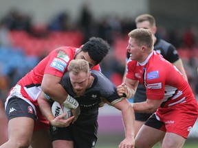 Toronto Wolfpack’s Tom Olbison is tackled during Saturday’s game against the Salford Red Devils. 
(Steve Gaunt/Touchlinepics Sports and Event Photography)