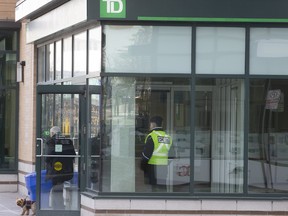 After a rash of bank robberies in and around the GTA, security has been stepped up at many branches. A security guard is seen here posted at the door to a TD branch near Don Mills Rd. and Lawrence Ave. E. in Toronto on Saturday, Feb. 15, 2020. (Stan Behal/Toronto Sun/Postmedia Network)