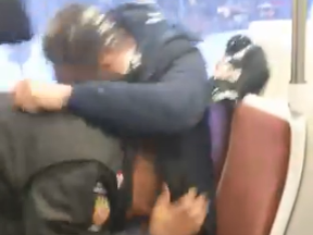 Screengrab of an altercation that broke out on a TTC Queen streetcar Friday morning.