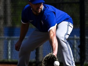 Blue Jays infielder Travis Shaw fields a ball during spring training at Spectrum Field in Dunedin, Fla., yesterday. USA TODAY