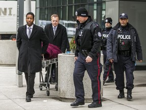 The first of two bodies is removed at the scene of a shooting from the previous night at 85 Queens Wharf Rd. In Toronto on Saturday, Feb. 1, 2020. Three young men were killed and two others injured when gunfire erupted during a party at an Airbnb condo at this address. (Ernest Doroszuk/Toronto Sun/Postmedia Network)