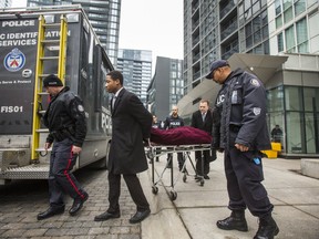 The first of two bodies is removed at the scene of a shooting from the previous night at 85 Queens Wharf Rd. In Toronto on Saturday, Feb. 1, 2020. Three young men were killed and two others injured when gunfire erupted during a party at an Airbnb condo at this address.
