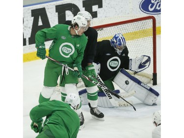 Toronto Maple Leafs Travis Dermott D (23) and  Auston Matthews C (34) in front of goalie Jack Campbell as Mitch Marner takes a shot during practice in Toronto on Wednesday February 19, 2020. Jack Boland/Toronto Sun/Postmedia Network