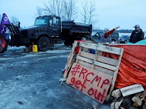 A snowplow is parked at a railway crossing as First Nations members of the Tyendinaga Mohawk Territory block train tracks servicing Via Rail, as part of a protest against B.C.'s Coastal GasLink pipeline, in Tyendinaga, Ont., on Wednesday, Feb. 12, 2020.