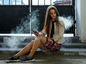 A teenaged girl vaping.